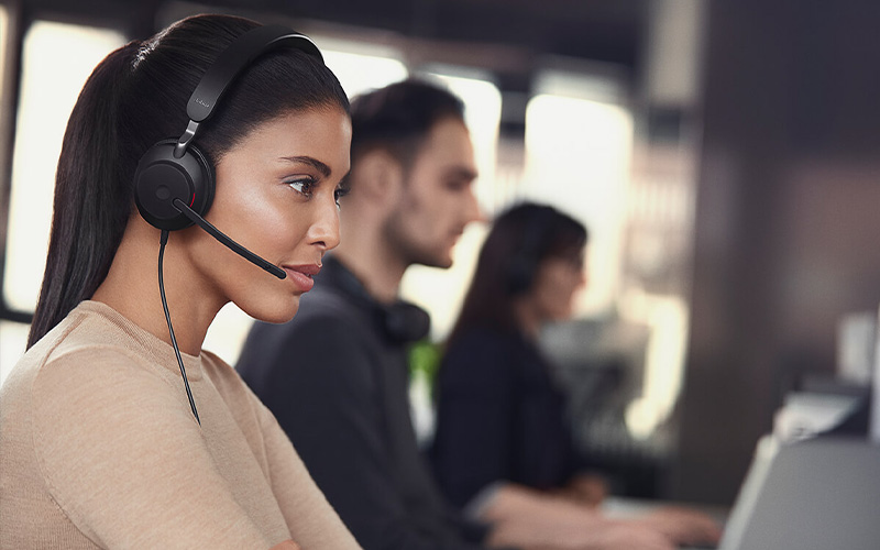 smiling woman talking through an Evolve2 40 headset