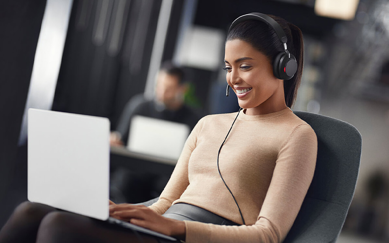 Woman smiling while wearing a Jabra headset