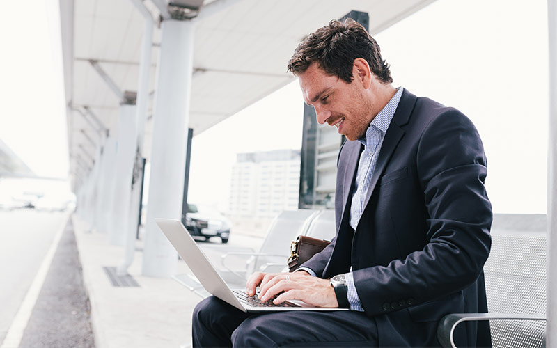man in suit on a laptop