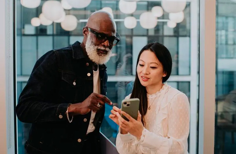 Colleagues looking at a mobile phone