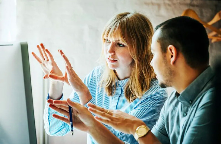 Man and woman working on a PC