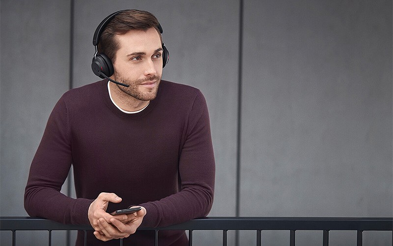 Man smiling while using the Evolve2 65 on a call