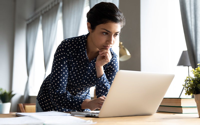 A woman studying infront of her laptop