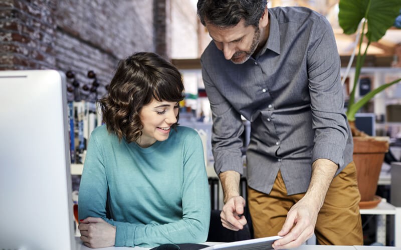 Two colleagues sharing a tablet in a meeting