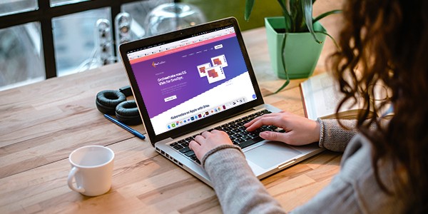 woman working on a laptop with a cup of coffee