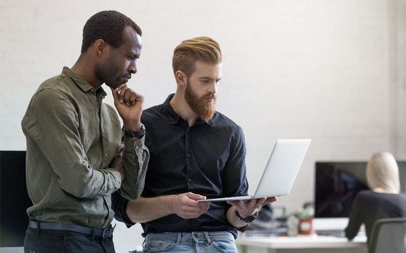 Two man looking at laptop