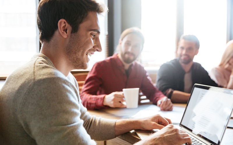 Man using laptop smiling